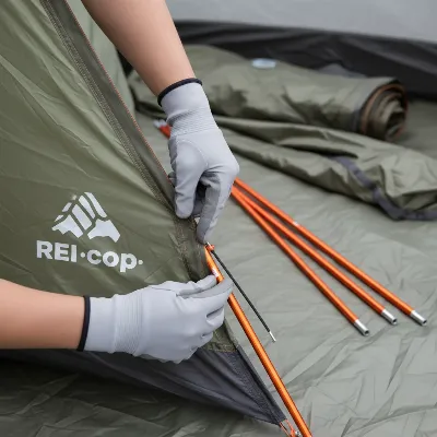 Hands setting up a pole on the REI Co-op Base Camp 6 tent