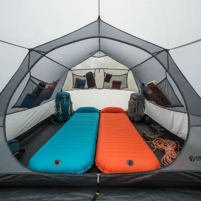 Interior shot of the Big Agnes Copper Spur tent, showcasing the headroom, internal pockets, and space for two sleeping pads and gear.
